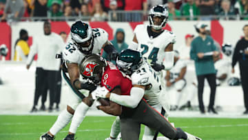 Jan 15, 2024; Tampa, Florida, USA; Tampa Bay Buccaneers wide receiver David Moore (19) is tackled by Philadelphia Eagles linebacker Zach Cunningham (52) and safety Kevin Byard (31) during the first half of a 2024 NFC wild card game at Raymond James Stadium. Mandatory Credit: Kim Klement Neitzel-Imagn Images