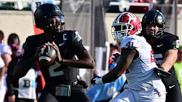 Nov 2, 2024; East Lansing, Michigan, USA; Michigan State Spartans quarterback Aidan Chiles (2) throws under pressure from Indiana Hoosiers defensive lineman Lanell Carr Jr. (41) during the first quarter at Spartan Stadium. Mandatory Credit: Dale Young-Imagn Images