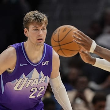 Mar 31, 2025; Charlotte, North Carolina, USA; Utah Jazz forward Kyle Filipowski (22) watches Charlotte Hornets center Mark Williams (5) as he passes the ball during the second half at Spectrum Center. Mandatory Credit: Jim Dedmon-Imagn Images