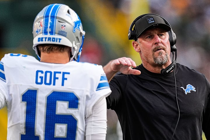 Detroit Lions head coach Dan Campbell pats quarterback Jared Goff on the shoulder before a play against the Green Bay Packers