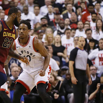 May 1, 2018; Toronto, Ontario, CAN; Cleveland Cavaliers forward LeBron James (23) tries to dribble arund Toronto Raptors guard DeMar DeRozan (10) during game one of the second round of the 2018 NBA Playoffs at Air Canada Centre. Cleveland defeated Toronto in overtime. Mandatory Credit: John E. Sokolowski-Imagn Images