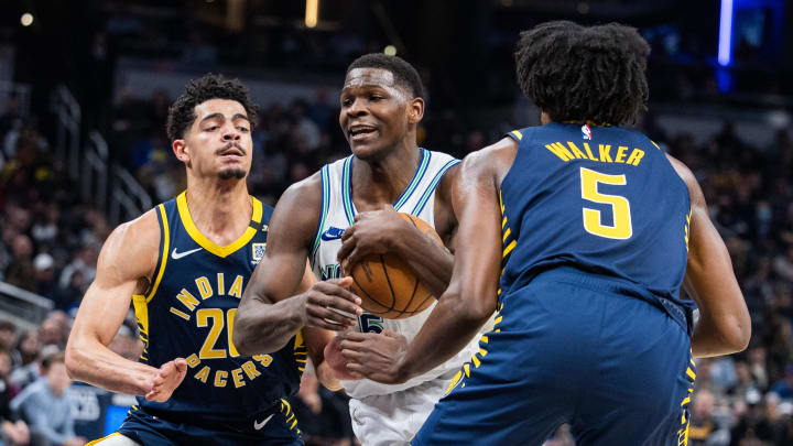 Mar 7, 2024; Indianapolis, Indiana, USA; Minnesota Timberwolves guard Anthony Edwards (5) dribbles the ball while Indiana Pacers guard Ben Sheppard (26) and forward Jarace Walker (5) defend during the first half at Gainbridge Fieldhouse. Mandatory Credit: Trevor Ruszkowski-USA TODAY Sports