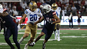 Nov 4, 2023; Tucson, Arizona, USA; Arizona Wildcats wide receiver Tetairoa McMillan #4 makes a catch for a first down against UCLA Bruins linebacker Kain Medrano #20 during the first half at Arizona Stadium. 