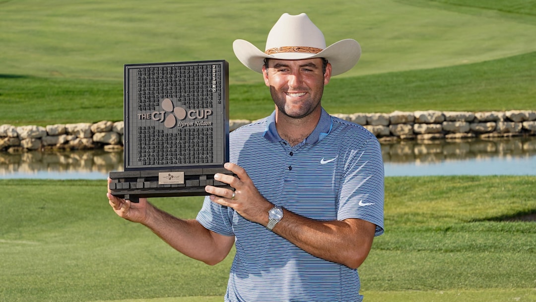 May 4, 2025; McKinney, Texas, USA; Scottie Scheffler poses with the winner's trophy during the final round of the THE CJ CUP Byron Nelson golf tournament. Scheffler won with a score of 31-under par for the tournament. Mandatory Credit: Raymond Carlin III-Imagn Images