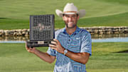 May 4, 2025; McKinney, Texas, USA; Scottie Scheffler poses with the winner's trophy during the final round of the THE CJ CUP Byron Nelson golf tournament. Scheffler won with a score of 31-under par for the tournament. Mandatory Credit: Raymond Carlin III-Imagn Images