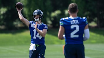 Jun 11, 2025; Renton, WA, USA; Seattle Seahawks quarterback Sam Darnold (14) passes the ball to quarterback Drew Lock (2) during mini-camp at Virginia Mason Athletic Center. 