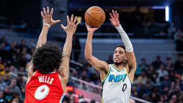 Feb 20, 2025; Indianapolis, Indiana, USA; Indiana Pacers guard Tyrese Haliburton (0) shoots the ball while Memphis Grizzlies forward Jaylen Wells (0) defends in the second half at Gainbridge Fieldhouse. Mandatory Credit: Trevor Ruszkowski-Imagn Images