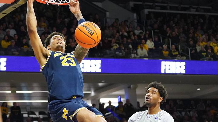 Feb 11, 2026; Evanston, Illinois, USA; Michigan Wolverines forward Yaxel Lendeborg (23) dunks the ball on Northwestern Wildcats forward Arrinten Page (22) during the first half at Welsh-Ryan Arena. Mandatory Credit: David Banks-Imagn Images
