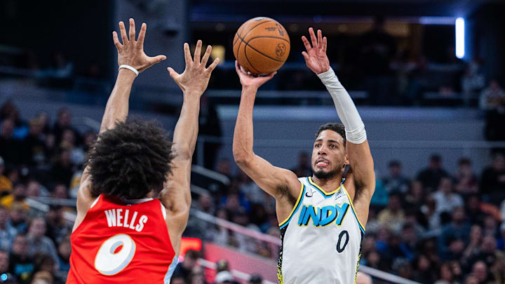 Feb 20, 2025; Indianapolis, Indiana, USA; Indiana Pacers guard Tyrese Haliburton (0) shoots the ball while Memphis Grizzlies forward Jaylen Wells (0) defends in the second half at Gainbridge Fieldhouse. Mandatory Credit: Trevor Ruszkowski-Imagn Images
