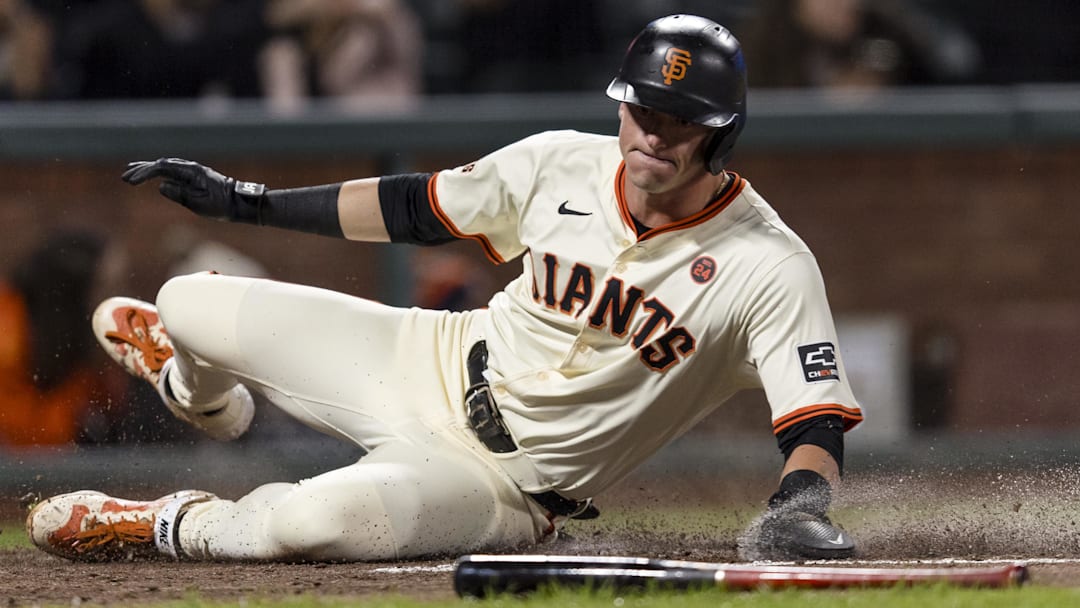 Sep 11, 2024; San Francisco, California, USA; San Francisco Giants shortstop Tyler Fitzgerald (49) slides home to score against the Milwaukee Brewers during the fourth inning at Oracle Park.