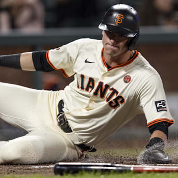 Sep 11, 2024; San Francisco, California, USA; San Francisco Giants shortstop Tyler Fitzgerald (49) slides home to score against the Milwaukee Brewers during the fourth inning at Oracle Park.