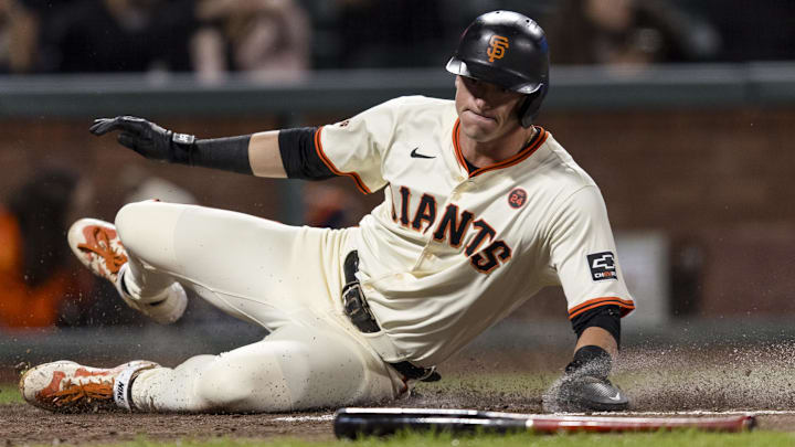 Sep 11, 2024; San Francisco, California, USA; San Francisco Giants shortstop Tyler Fitzgerald (49) slides home to score against the Milwaukee Brewers during the fourth inning at Oracle Park.