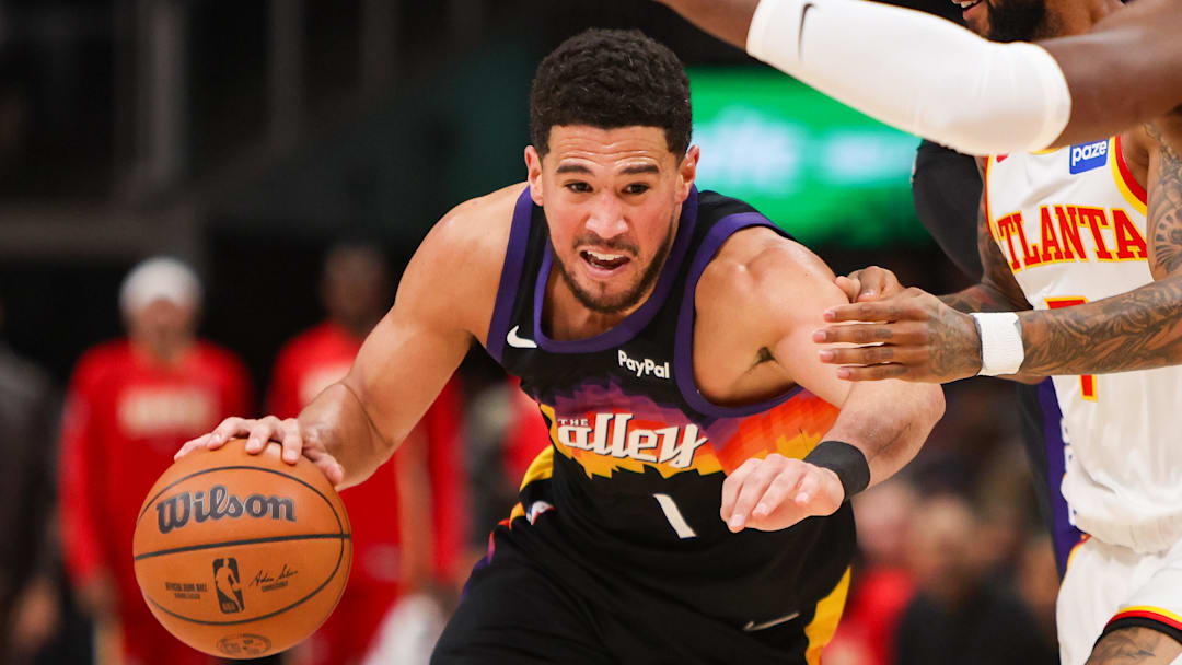 Jan 23, 2026; Atlanta, Georgia, USA; Phoenix Suns guard Devin Booker (1) drives to the basket against the Atlanta Hawks in the first quarter at State Farm Arena. Mandatory Credit: Brett Davis-Imagn Images
