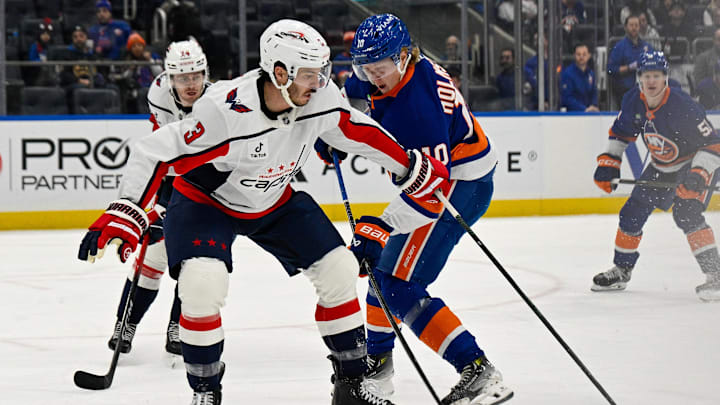 Nov 30, 2025; Elmont, New York, USA;  Washington Capitals defenseman Matt Roy (3) blocks the shot by New York Islanders right wing Simon Holmstrom (10) during the second period at UBS Arena. Mandatory Credit: Dennis Schneidler-Imagn Images