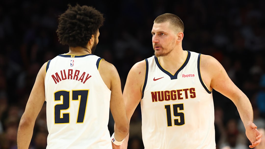 Mar 24, 2026; Phoenix, Arizona, USA; Denver Nuggets center Nikola Jokic (15) with guard Jamal Murray (27) against the Phoenix Suns in the second half at Mortgage Matchup Center.