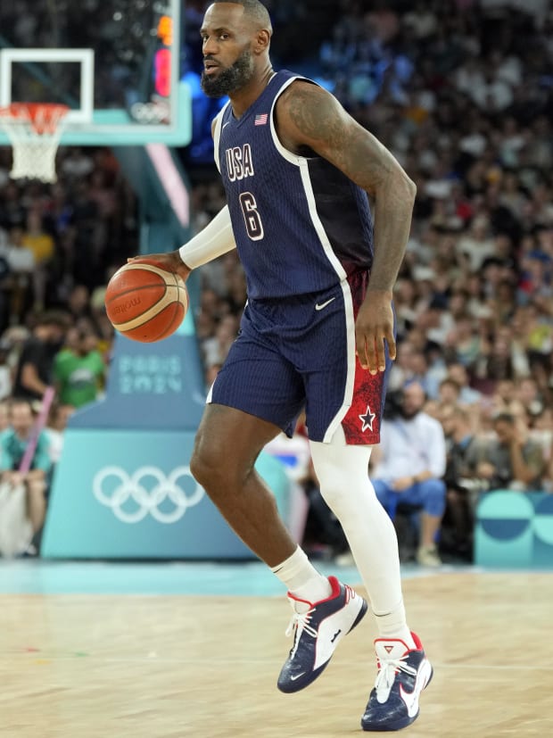 Team USA forward LeBron James dribbles the basketball.