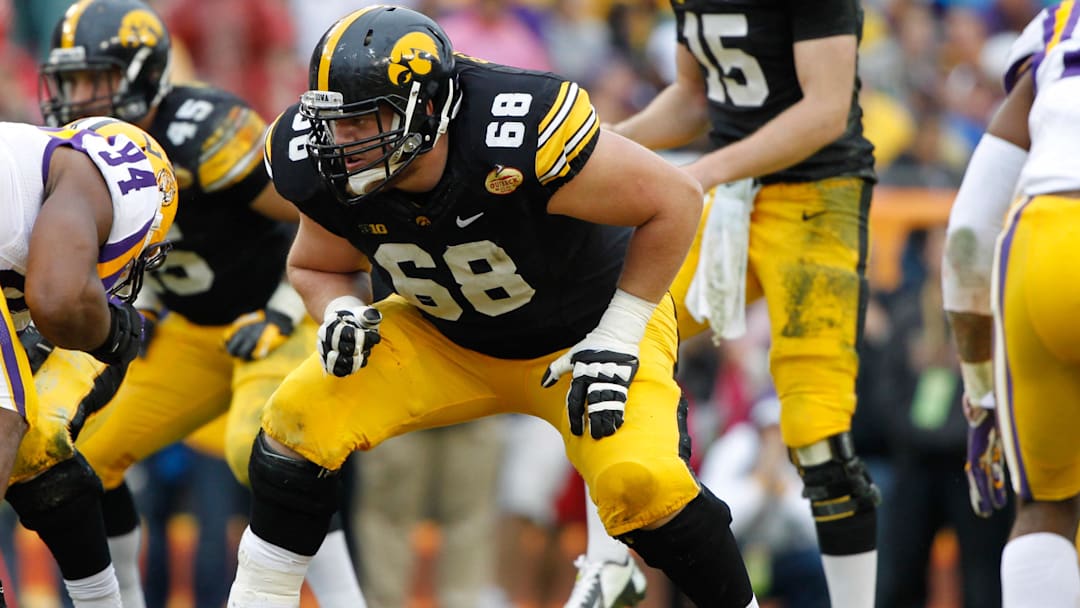 Jan 1, 2014; Tampa, Fl, USA; Iowa Hawkeyes offensive linesman Brandon Scherff (68) blocks against the LSU Tigers during the first half at Raymond James Stadium. Mandatory Credit: Kim Klement-Imagn Images