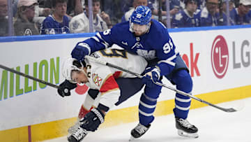 May 18, 2025; Toronto, Ontario, CAN; Toronto Maple Leafs defenceman Oliver Ekman-Larsson (95) checks Florida Panthers forward Brad Marchand (63) during the second period of game seven of the second round of the 2025 Stanley Cup Playoffs at Scotiabank Arena. Mandatory Credit: John E. Sokolowski-Imagn Images