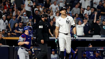 Oct 30, 2024; New York, New York, USA; New York Yankees designated hitter Giancarlo Stanton (27) reacts after hitting a home run during the third inning against the Los Angeles Dodgers in game five of the 2024 MLB World Series at Yankee Stadium. Mandatory Credit: Vincent Carchietta-Imagn Images