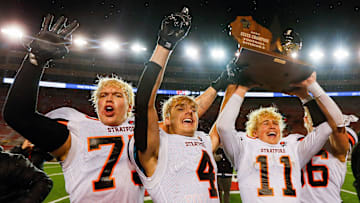 Stratford High School's Walker Weis (75), Jett Schoenherr (4), Jack Tubbs (11) and Carter Lueck (66) hoist the championship trophy as they celebrate after defeating Wrightstown High School during the WIAA Division 5 state championship game on Thursday, November 21, 2024, at Camp Randall Stadium in Madison, Wis. Stratford won the game, 21-6.
Tork Mason/USA TODAY NETWORK-Wisconsin