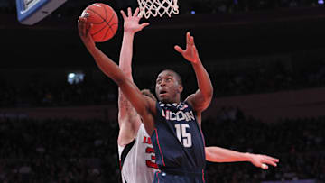 Connecticut Huskies guard Kemba Walker (15) scores during the first half past Louisville Cardinals guard Mike Marra in the final round of the Big East Tournament held at Madison Square Garden. 