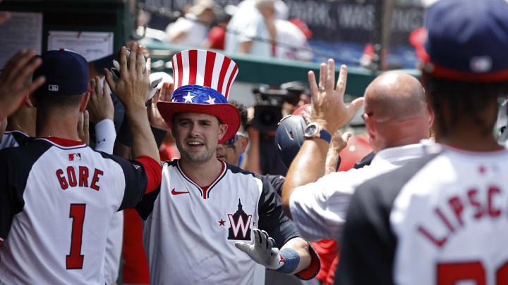 Jun 20, 2024; Washington, District of Columbia, USA;  Washington Nationals outfielder Lane Thomas (28) celebrates with teammates while wearing the Home Run top hat in the dugout after hitting a solo home run against the Arizona Diamondbacks during the third inningat Nationals Park. Mandatory Credit: Geoff Burke-USA TODAY Sports