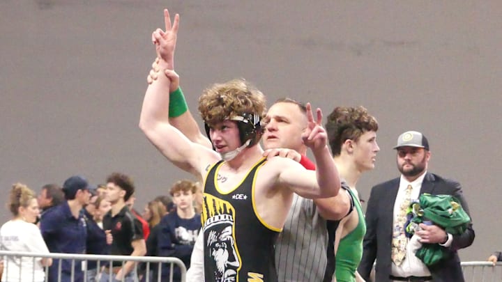 Philomath junior Riley Barrett celebrates winning a second Class 4A wrestling title.