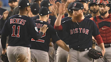 Boston Red Sox third baseman Rafael Devers (11) celebrates with pitcher Craig Kimbrel after defeating the Los Angeles Dodgers in game four of the 2018 World Series at Dodger Stadium. 