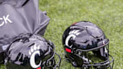 Oct 30, 2021; New Orleans, Louisiana, USA;  Cincinnati Bearcats helmets on the ground during the game against Tulane Green Wave during the second half at Yulman Stadium. Mandatory Credit: Stephen Lew-Imagn Images