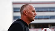 Aug 28, 2025; Raleigh, North Carolina, USA; North Carolina State Wolfpack head coach Dave Doeren looks on during the warmups prior to the game against East Carolina Pirates at Carter-Finley Stadium. Mandatory Credit: Jaylynn Nash-Imagn Images