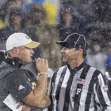 Dec 27, 2024; Birmingham, AL, USA;  Georgia Tech Yellow Jackets head coach Brent Key talks with a referee before a weather delay during the second half of the 2024 Birmingham Bowl at Protective Stadium. Mandatory Credit: Vasha Hunt-Imagn Images