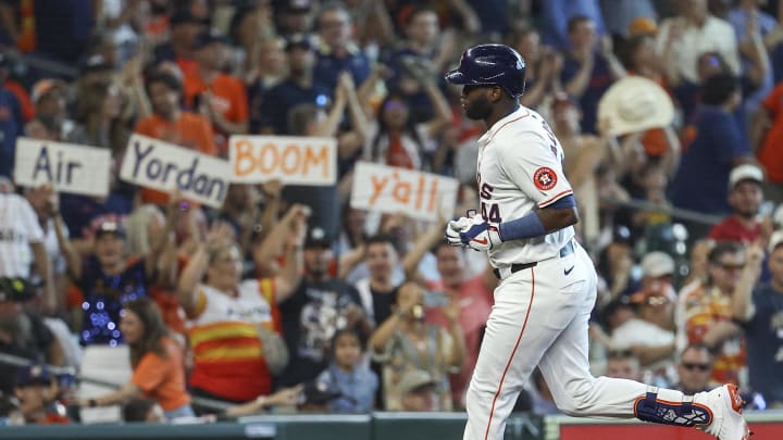 Jun 22, 2024; Houston, Texas, USA; Fans hold signs as Houston Astros designated hitter Yordan Alvarez (44) rounds the bases after hitting a home run during the third inning against the Baltimore Orioles at Minute Maid Park. Mandatory Credit: Troy Taormina-USA TODAY Sports