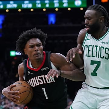 Jan 27, 2025; Boston, Massachusetts, USA; Houston Rockets forward Amen Thompson (1) drives the ball to the basket against Boston Celtics guard Jaylen Brown (7) in the last seconds of then game at TD Garden. Mandatory Credit: David Butler II-Imagn Images