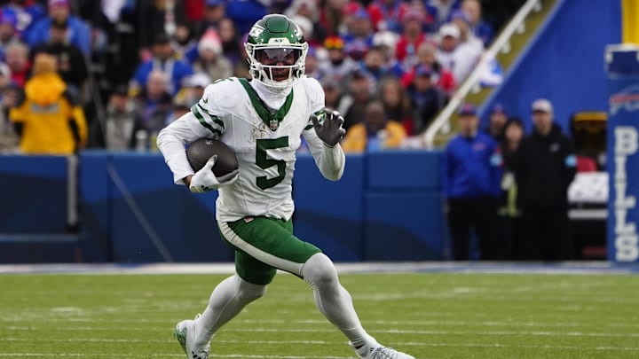 New York Jets wide receiver Garrett Wilson runs with the ball after making a catch against the Buffalo Bills.