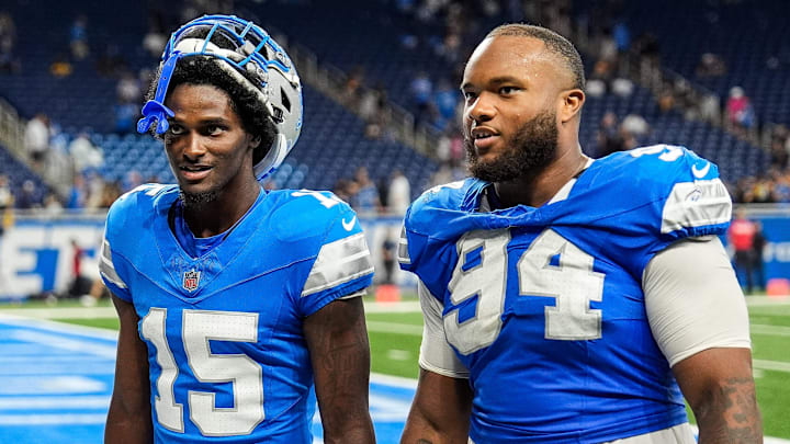 Detroit Lions cornerback Ennis Rakestraw Jr. (15), left, talks to defensive tackle Mekhi Wingo (94)