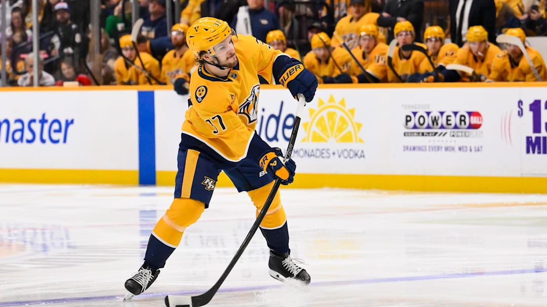 Jan 11, 2026; Nashville, Tennessee, USA;  Nashville Predators defenseman Nick Blankenburg (37) takes a shot on goal against the Washington Capitals during the third period at Bridgestone Arena. Mandatory Credit: Steve Roberts-Imagn Images