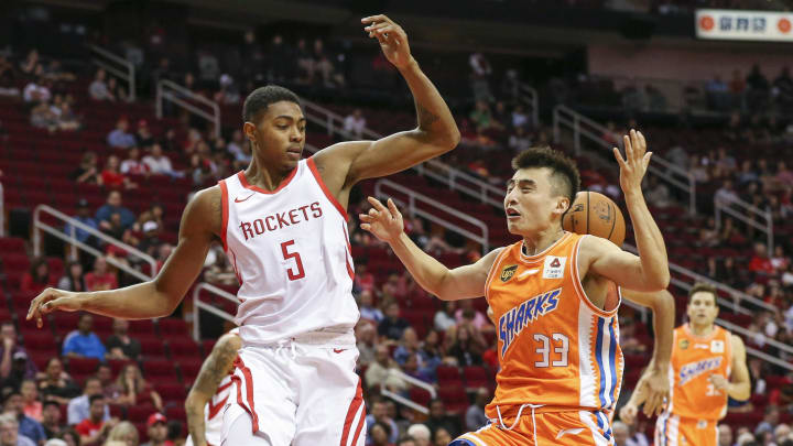 Oct 9, 2018; Houston, Tx, USA; Shanghai Sharks guarrd Luo Hanchen (33) loses control of the ball as Houston Rockets forward Bruno Caboclo (5) defends during the third quarter at Toyota Center. Mandatory Credit: Troy Taormina-USA TODAY Sports