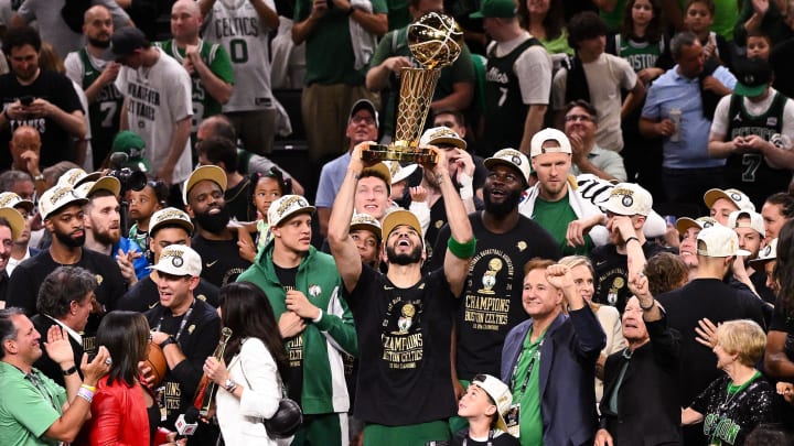 Jun 17, 2024; Boston, Massachusetts, USA; Boston Celtics forward Jayson Tatum (0) holds up the Larry O'Brien Championship Trophy after the Celtics beat the Dallas Mavericks in game five of the 2024 NBA Finals at the TD Garden. 