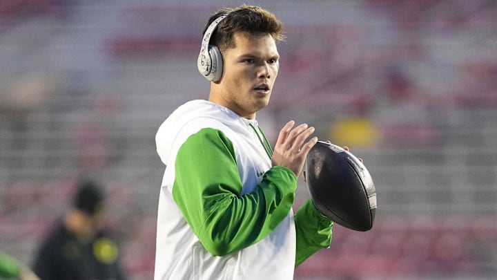 Nov 16, 2024; Madison, Wisconsin, USA; Oregon Ducks quarterback Dillon Gabriel (8) throws a pass during warmups prior to the game against the Wisconsin Badgers at Camp Randall Stadium. Nov 16, 2024; Madison, Wisconsin, USA; Oregon Ducks quarterback Dillon Gabriel (8) throws a pass during warmups prior to the game against the Wisconsin Badgers at Camp Randall Stadium.