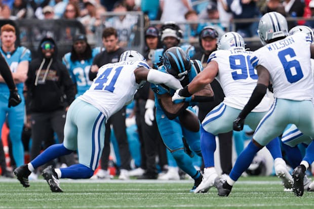 Dallas Cowboys defensive end Donovan Ezeiruaku forces a fumble from Carolina Panthers running back Rico Dowdle 