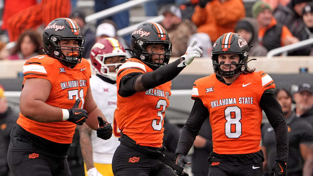 Oklahoma State's Cam Smith (3) celebrates a play with Aden Kelley (71) and Parker Robertson (8) in the first half of the college football game between the Oklahoma State Cowboys and the Iowa State Cyclones at Boone Pickens Stadium in Stillwater, Okla., Saturday Nov. 29, 2025.