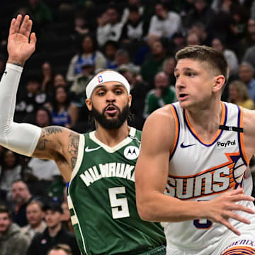 Apr 1, 2025; Milwaukee, Wisconsin, USA;  Phoenix Suns guard Grayson Allen (8) drives for the basket against Milwaukee Bucks guard Gary Trent Jr. (5) in the second quarter at Fiserv Forum. Mandatory Credit: Benny Sieu-Imagn Images