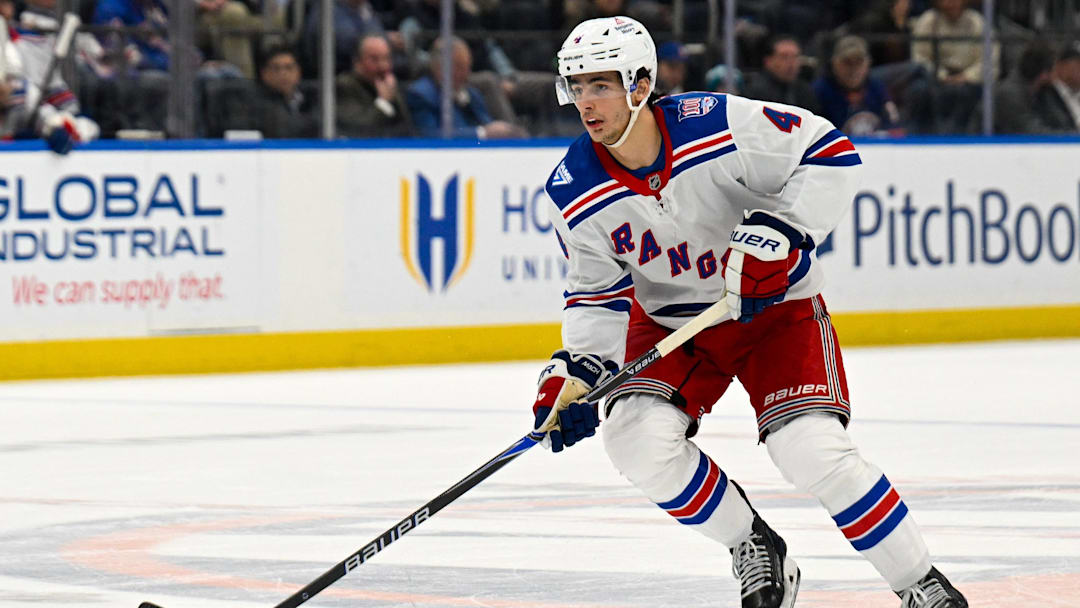 Jan 28, 2026; Elmont, New York, USA;  New York Rangers defenseman Braden Schneider (4) skates with the puck against the New York Islanders during the first period at UBS Arena. Mandatory Credit: Dennis Schneidler-Imagn Images