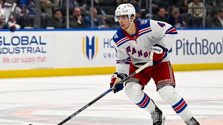 Jan 28, 2026; Elmont, New York, USA;  New York Rangers defenseman Braden Schneider (4) skates with the puck against the New York Islanders during the first period at UBS Arena. Mandatory Credit: Dennis Schneidler-Imagn Images