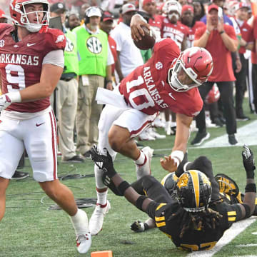 Arkansas Razorbacks quarterback Taylen Green is brought down by UAPB defenders out of bounds at War Memorial Stadium in Little Rock, Ark.