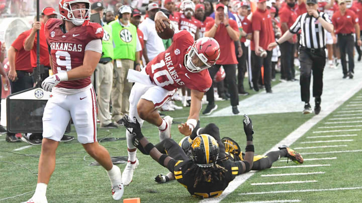 Arkansas Razorbacks quarterback Taylen Green is brought down by UAPB defenders out of bounds at War Memorial Stadium in Little Rock, Ark.