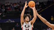 Mar 12, 2025; Nashville, TN, USA;  Georgia Bulldogs forward Asa Newell (14) shoots a three point basket against the Oklahoma Sooners during the first half at Bridgestone Arena.