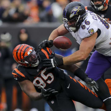 Jan 8, 2023; Cincinnati, Ohio, USA; Cincinnati Bengals defensive tackle Zach Carter (95) attempts to catch the tipped ball against Baltimore Ravens guard Ben Cleveland (66) in the second half at Paycor Stadium. Mandatory Credit: Katie Stratman-USA TODAY Sports
