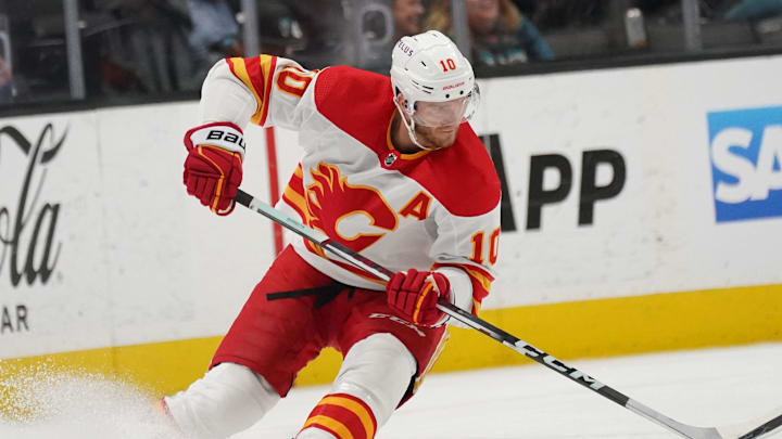 Apr 9, 2024; San Jose, California, USA; Calgary Flames center Jonathan Huberdeau (10) advances the puck against the San Jose Sharks during the first period at SAP Center at San Jose. Mandatory Credit: David Gonzales-Imagn Images