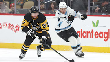Dec 14, 2025; Pittsburgh, Pennsylvania, USA;  Pittsburgh Penguins center Sidney Crosby (87) skates up ice with the puck as Utah Mammoth center Nick Schmaltz (8) chases during the first period  at PPG Paints Arena. Mandatory Credit: Charles LeClaire-Imagn Images